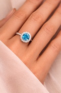 White Gold Blue Topaz Ring With Diamond Halo